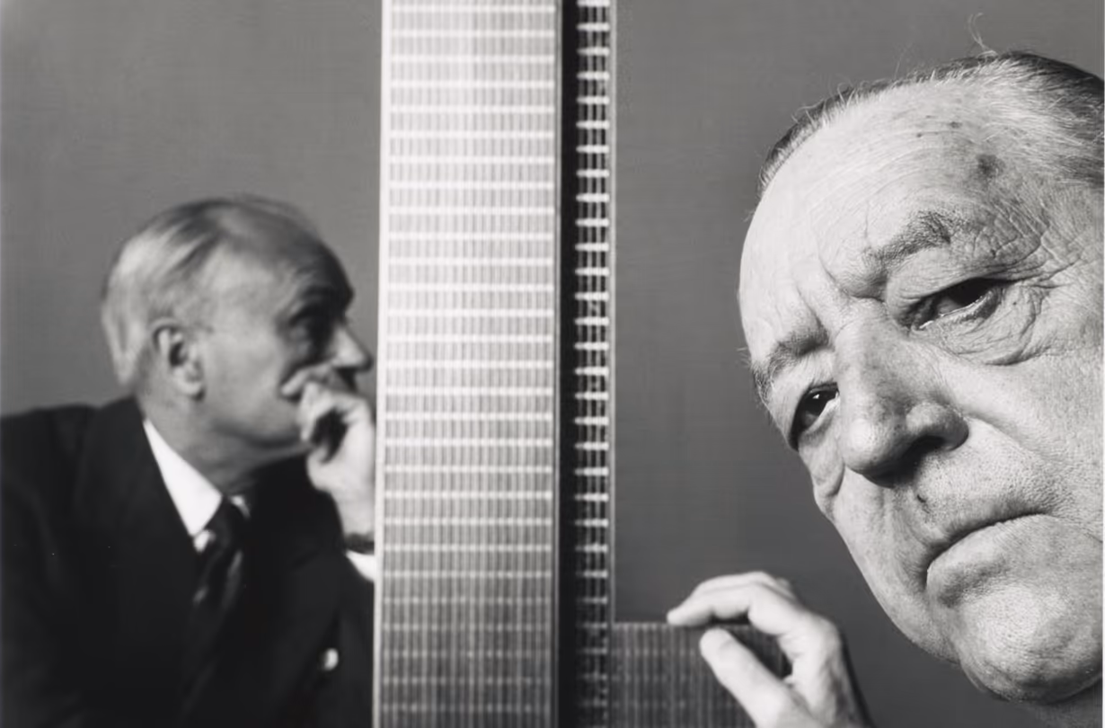 Ludwig Mies van der Rohe with an architectural model